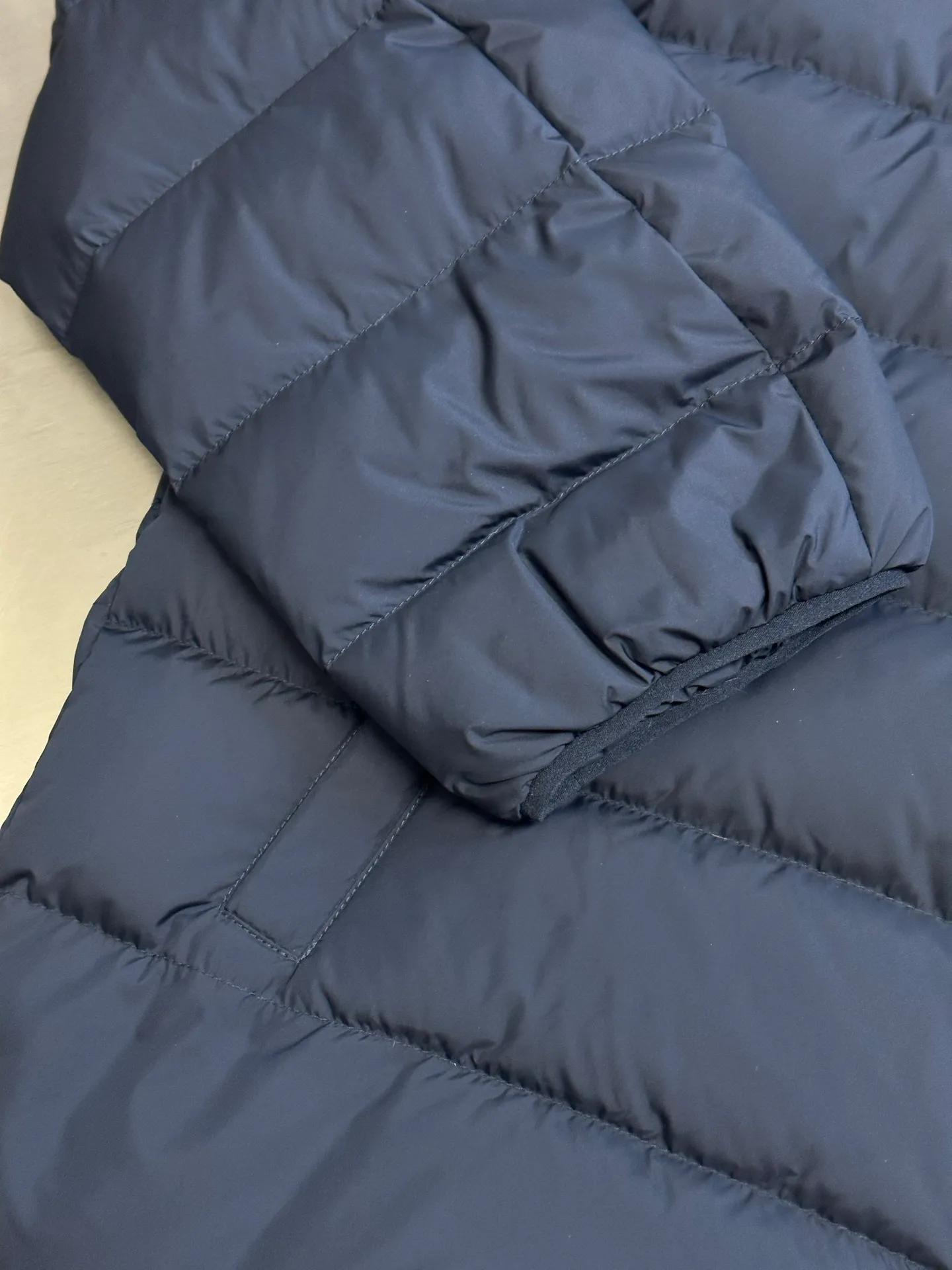 P890 Ralph Lauren lightweight down jacket. The nylon fabric has good windproof and waterproof properties, which can effectively block the intrusion of wind and rain from the outside and keep the inside dry. It is suitable for wearing in humid or rainy environments. The red label on the chest is made with an imported MECLO embroidery machine. The original pattern is scanned first, and then high-quality silk thread is used to make a pattern. The density effect is adjusted by continuous pattern making.  The zipper design is simple and elegant, easy to operate, and the closing design of the cuffs and hem effectively prevents cold wind from invading, improving the warmth and comfort of wearing. It uses 90 white duck down with a weight of 260g to ensure excellent thermal insulation performance. After strict screening and processing, the velvet is not easy to drill, ensuring durability. size: s m l xl